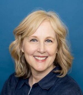 headshot of Kris Stawinski on a blue background